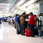 Line of people queueing at an airport